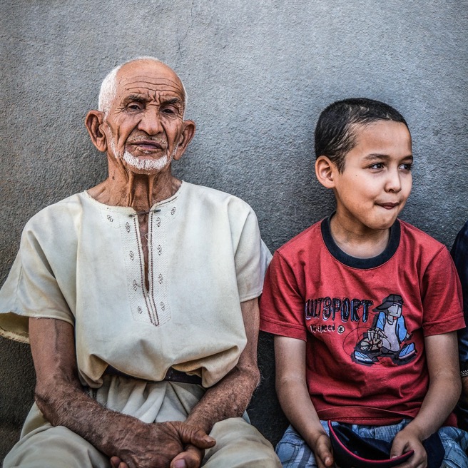 Grandfather and child sitting on a bench